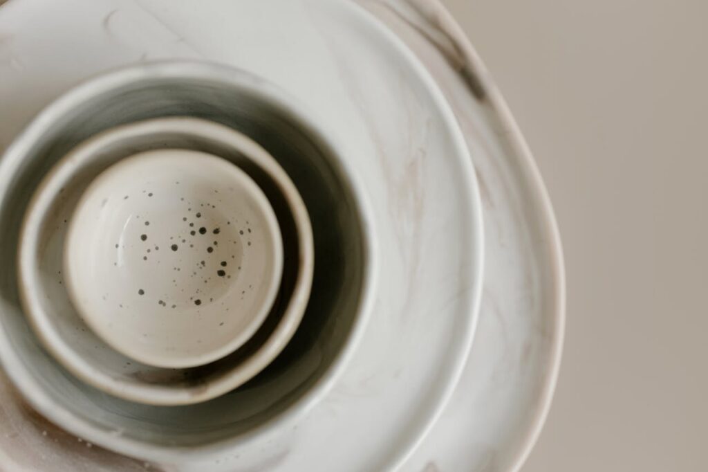 Aesthetic flat lay of stacked ceramic bowls showcasing minimalist design and muted tones.